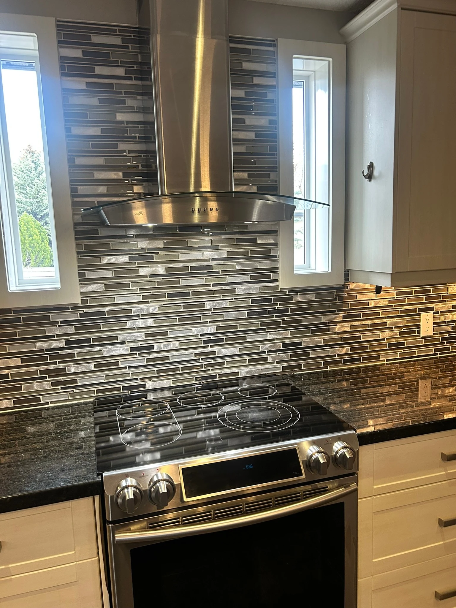 Clean kitchen with polished appliances and backsplash
